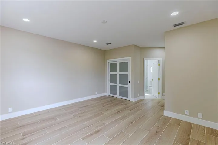 Spare room with light wood finished floors and recessed lighting