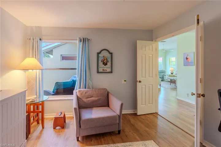 Living area with light wood-style floors and healthy amount of natural light