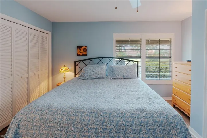Bedroom with a closet, a ceiling fan, and wood finished floors