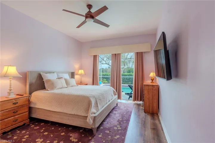 Bedroom with access to exterior, wood-type flooring, and ceiling fan