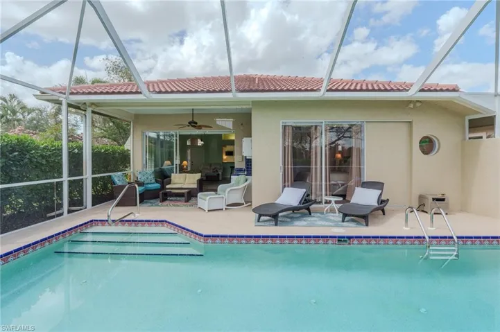 Outdoor pool featuring a lanai, a sunroom, an outdoor hangout area, and a patio area
