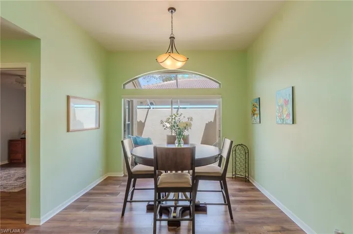 Dining area with dark wood finished floors and baseboards