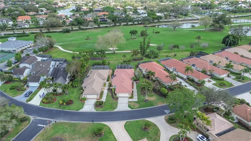 View of property location featuring a golf course and nearby suburban area