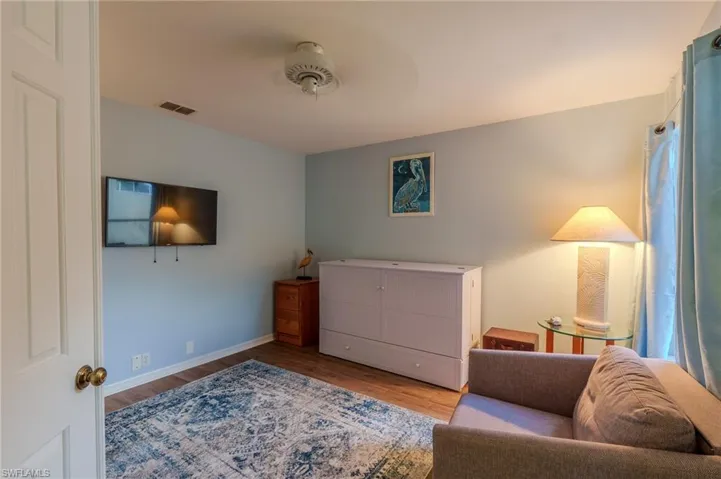 Living area with light wood-type flooring and baseboards