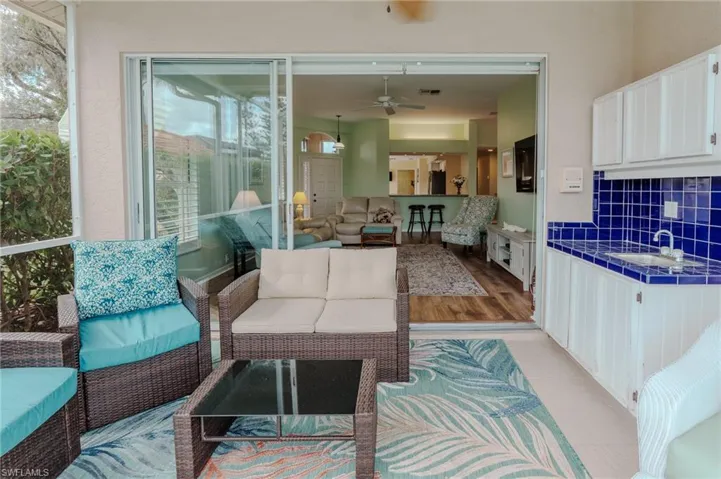 Living area with light wood-style floors and ceiling fan