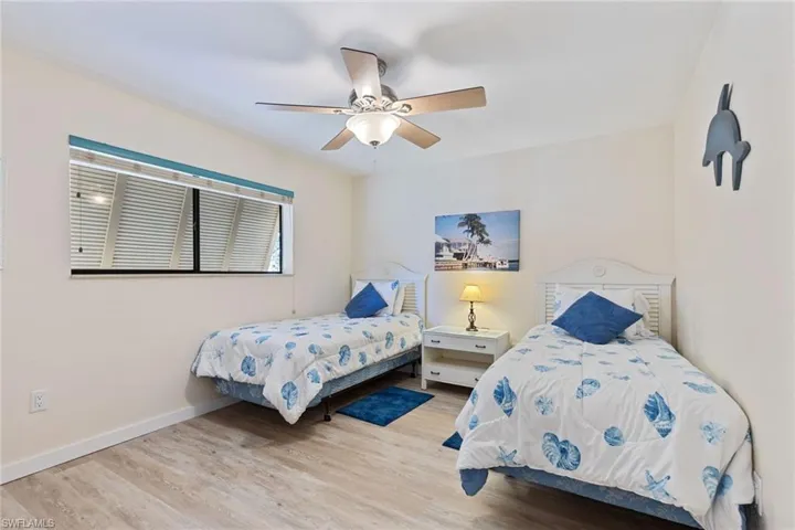 Bedroom with ceiling fan and light wood-type flooring
