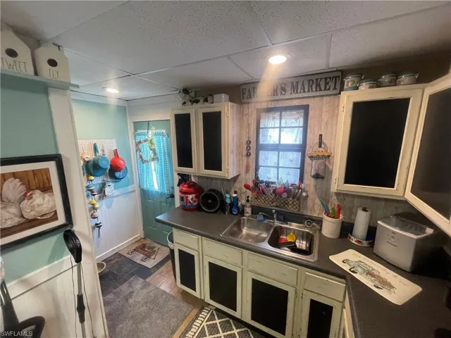 Kitchen featuring a drop ceiling, hardwood / wood-style floors, and sink