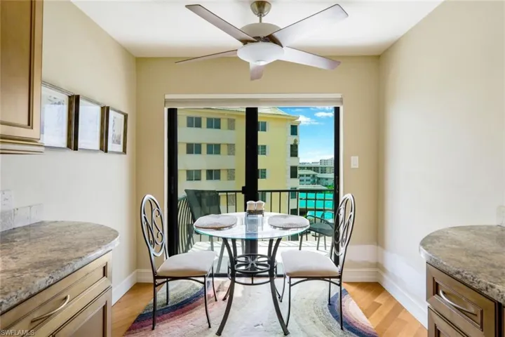 Dining area with light hardwood / wood-style flooring and ceiling fan