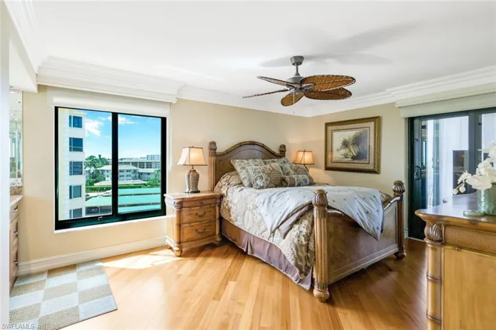 Bedroom featuring crown molding, hardwood / wood-style flooring, and ceiling fan