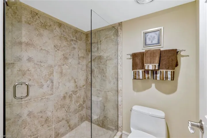 Bathroom featuring toilet and an enclosed shower