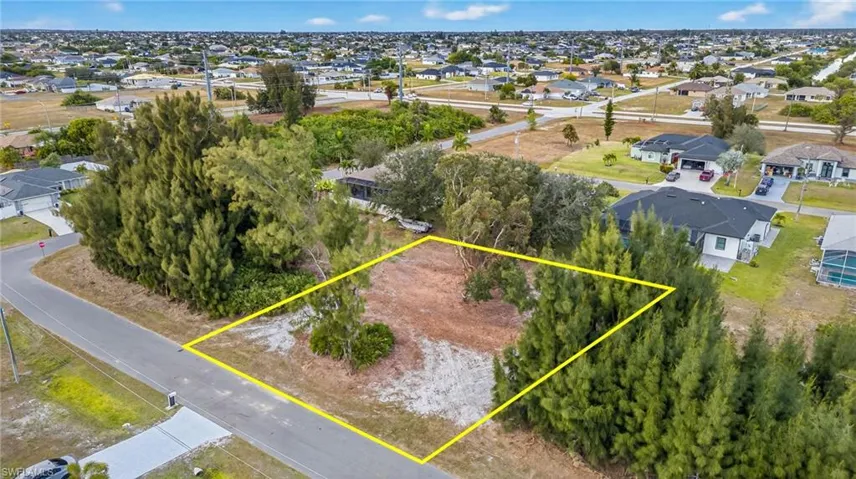 Aerial perspective of suburban area featuring property parcel outlined