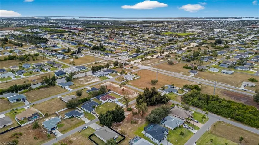 Aerial view of property's location featuring nearby suburban area