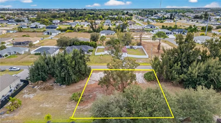Aerial perspective of suburban area featuring property boundaries highlighted