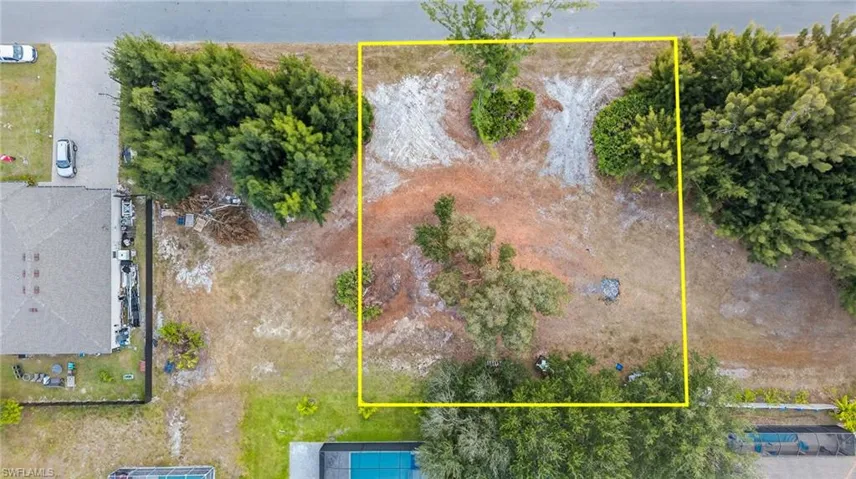 Aerial view of property and surrounding area featuring property parcel outlined