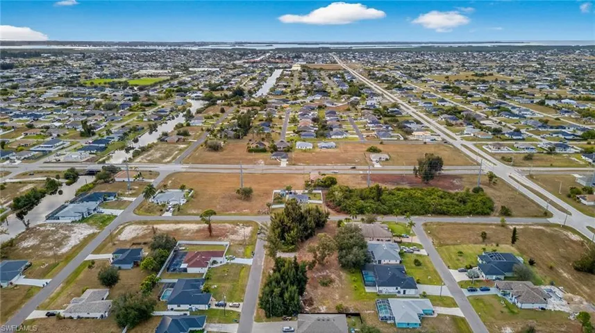 Aerial view of property's location with nearby suburban area