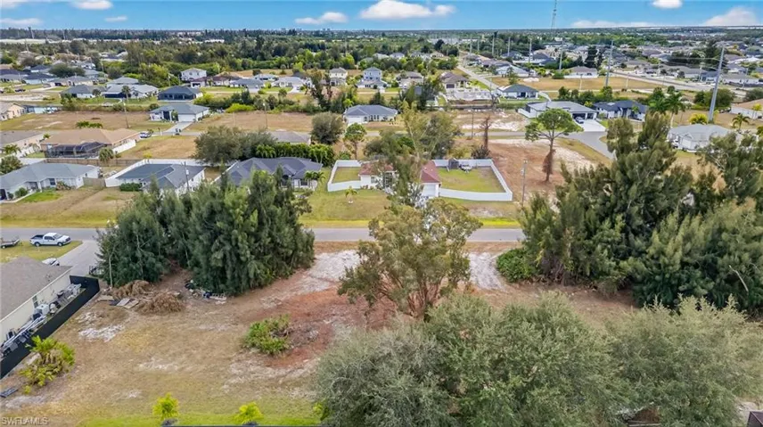 Aerial view of property's location with nearby suburban area