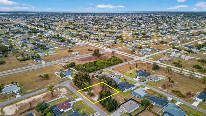 Aerial perspective of suburban area featuring property boundaries highlighted