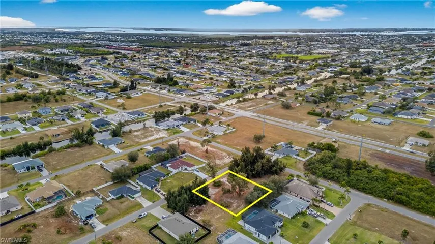 Aerial perspective of suburban area featuring property parcel outlined