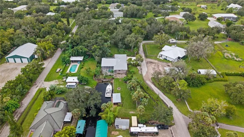 Aerial view of property's location with nearby suburban area