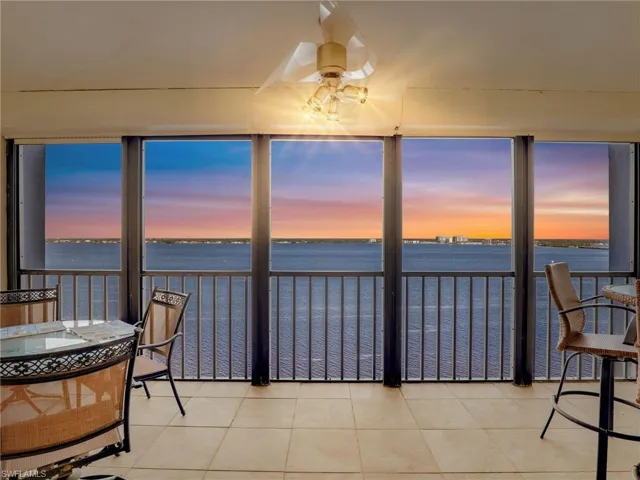 Sunroom featuring a vast water view