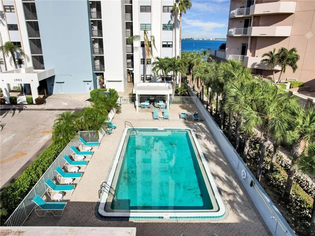 View of swimming pool featuring a patio and a water view