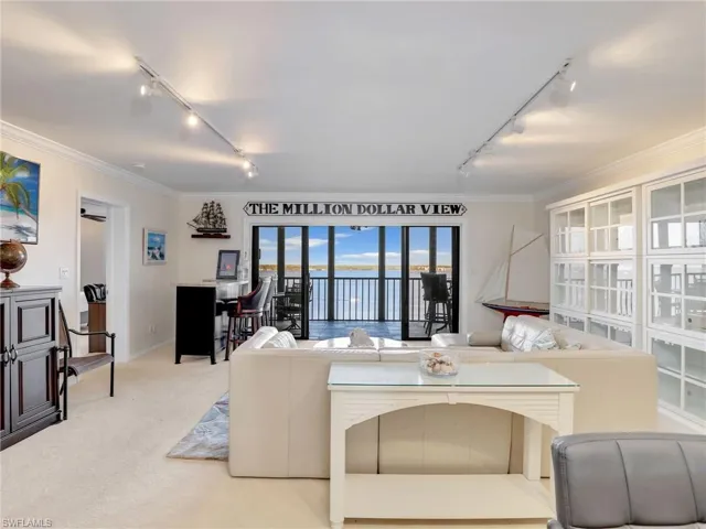 Living room with light carpet and water view