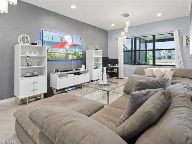 Living area with baseboards and recessed lighting