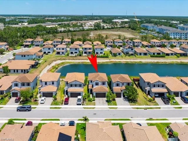 Aerial perspective of suburban area featuring a large body of water