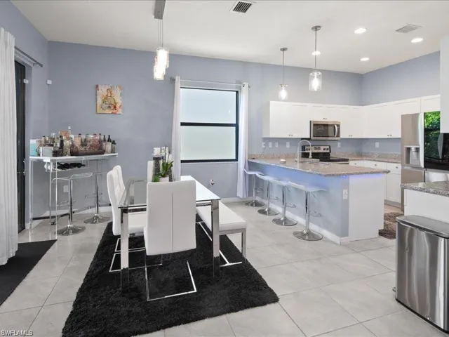 Dining room featuring plenty of natural light and light tile patterned flooring