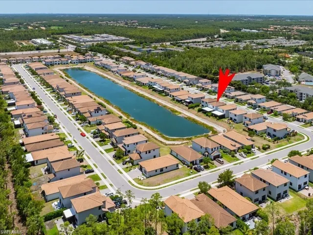 Aerial perspective of suburban area featuring a large body of water