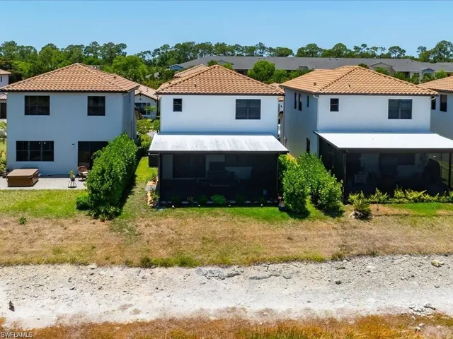 Rear view of property featuring a residential view, stucco siding, and a patio