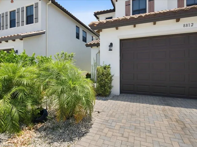 Garage featuring decorative driveway
