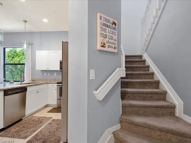Staircase featuring tile patterned flooring and recessed lighting
