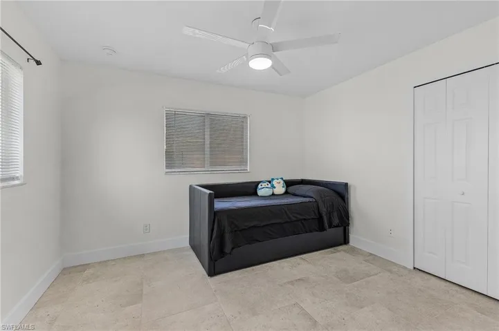 Tiled bedroom with ceiling fan