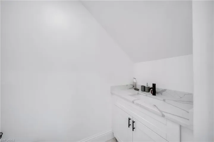 Bathroom with vanity and vaulted ceiling