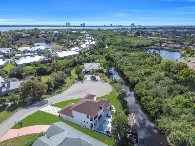 View of property location featuring a large body of water and nearby suburban area