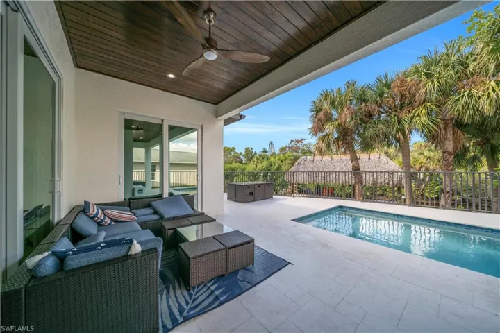 View of pool featuring patio surround, a fenced backyard, and an outdoor lounge area