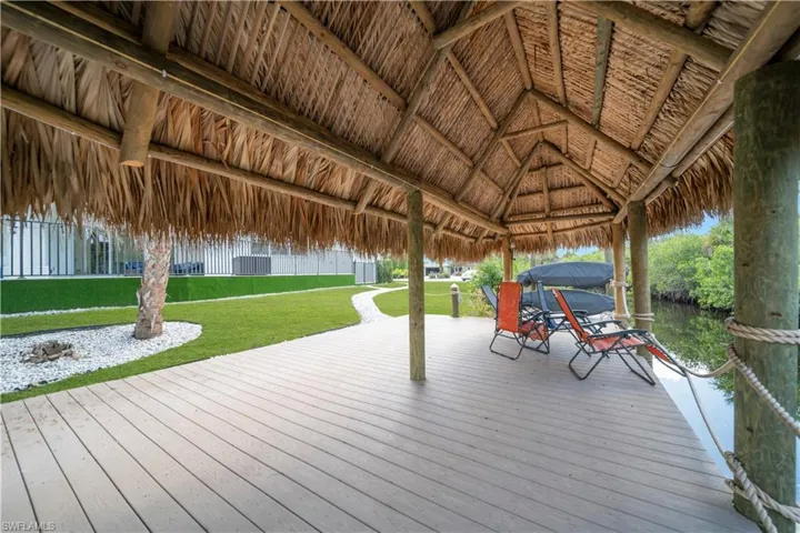 Deck with a yard and a water view
