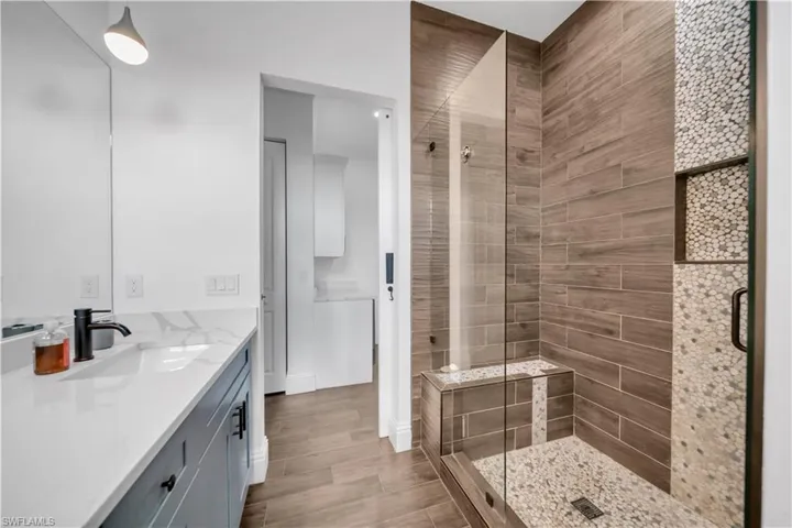 Bathroom featuring a shower stall and vanity