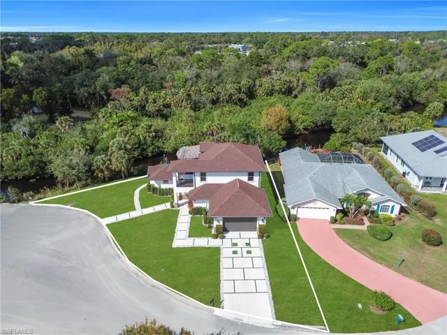 Aerial view of residential area featuring a forest