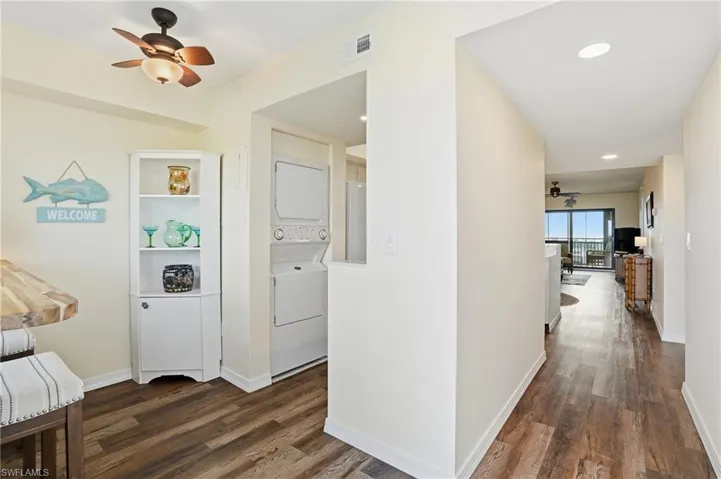 Hallway with stacked washer / drying machine, and recessed lighting - Virtually Edited Image