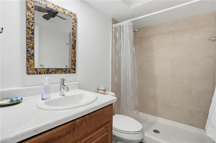 Guest bathroom with vanity and a shower - Virtually Edited Image