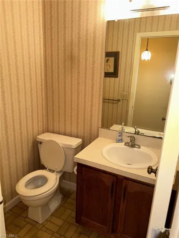 Bathroom with tile flooring, vanity, and toilet