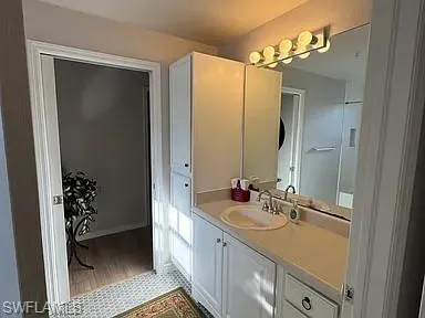 Bathroom featuring vanity and light wood-style floors