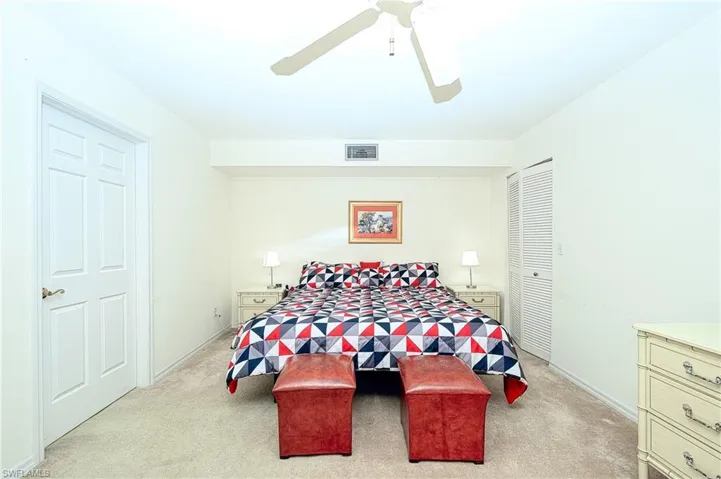 Carpeted bedroom with ceiling fan