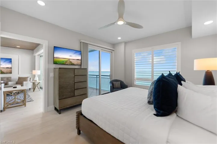 Bedroom with light wood finished floors, access to outside, a ceiling fan, and recessed lighting