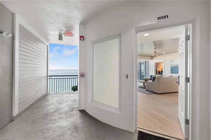 Corridor with a water view and concrete floors