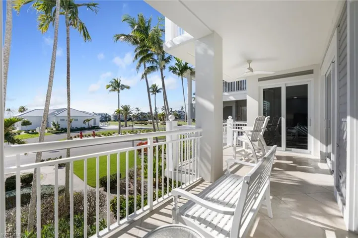 Porch featuring a ceiling fan and a residential view