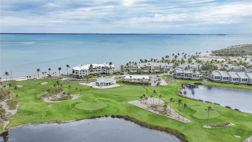 Aerial perspective of suburban area with a nearby body of water and a golf club