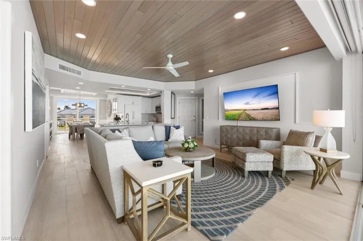 Living room with wood ceiling, light wood finished floors, a ceiling fan, and recessed lighting